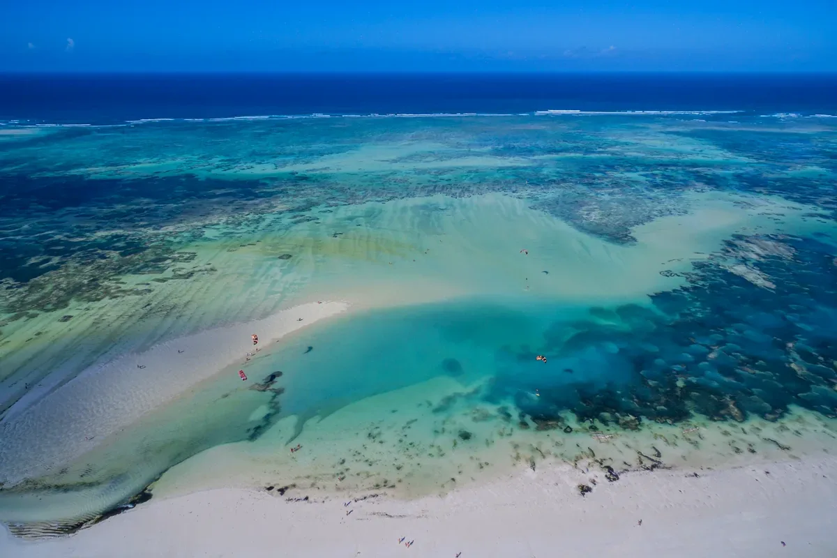 Banco de arena con arrecifes en un mar turquesa, visto desde el aire